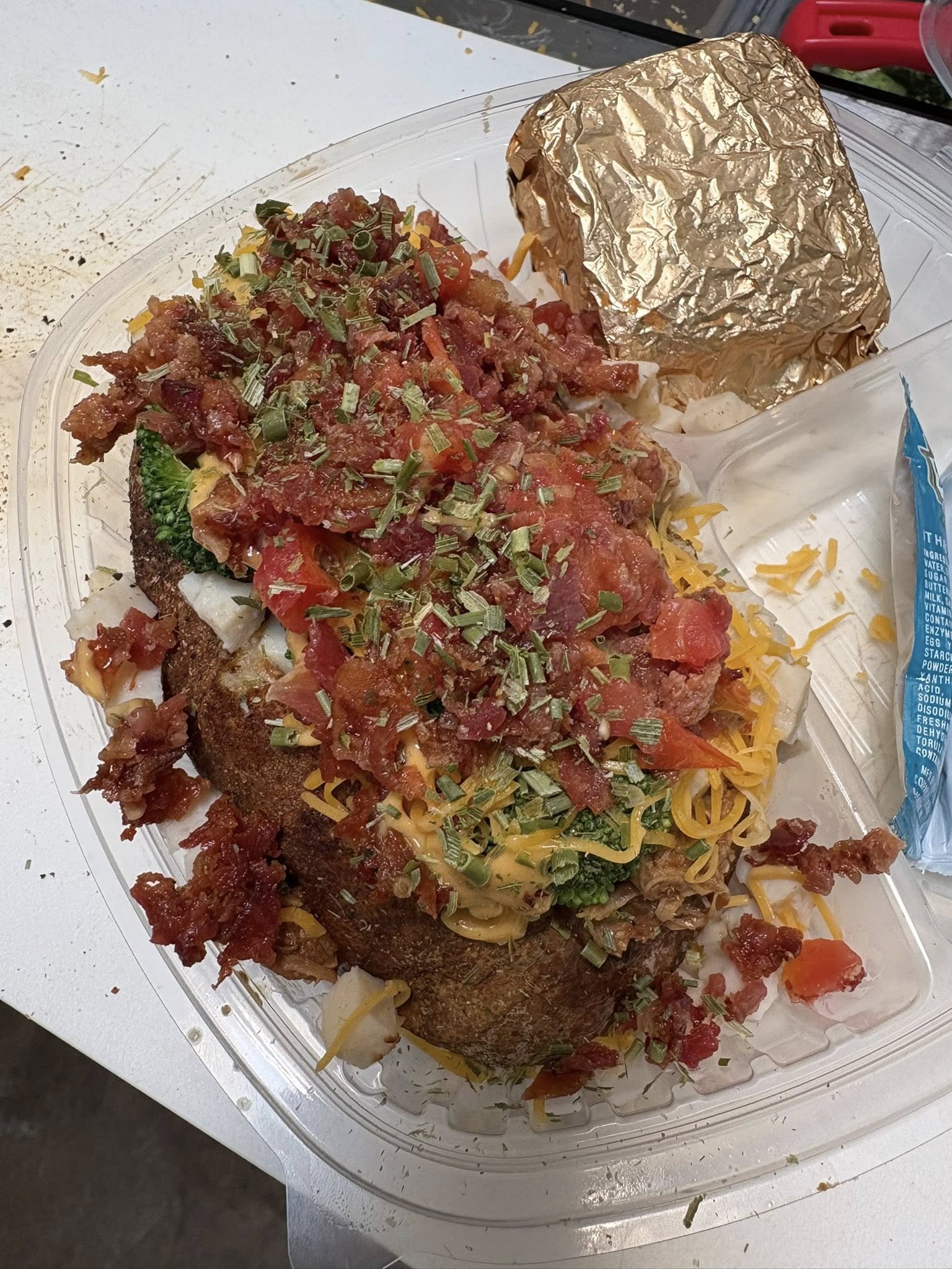 Fully loaded baked potato with bacon, cheddar and chives